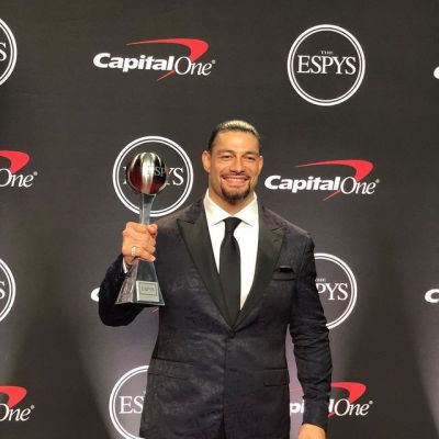 Roman Reigns taking award