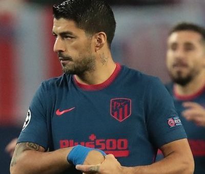 Luis Suarez is a famous professional football player who currently plays for Football Club Barcelona in the men’s top Spanish football division LaLiga Santander, commonly known as LaLiga. He is one of the best players today and is also one of the best strikers of his generation. Luis Suárez has achieved tremendous success and earned himself a lot of name and fame. He has 18 professional career trophies playing various events. Suarez is also infamously known for biting incidents on the pitch, but regardless, he is one of the best forwards the game has ever had. He is given El Pistolero, meaning ‘The Gunfighter’ because of his charismatic and bold personality and his ability to score goals from unusual distances and angles with the supervision of assisting his teammates. His jersey number is 9. Quick Info Full Name Luis Alberto Suarez Díaz Profession Football Player Birth Date January 24, 1987 Birth Place Salto, Uruguay Star Sign Aquarius Parents Father: Rodolfo Suarez Mother: Sandra Diaz Siblings 6 Wife Sofia Balbi Kids Delfina Suarez, Benjamin Suarez, Lautaro Suarez Net Worth $40 million Nationality Uruguayan Ethnicity Uruguayan Religion Roman Catholic Height 6 feet (1.82m/182cm) Weight 81kgs (179lbs) Eye Color Brown Hair Color Black Luis Suárez Bio Luis Suarez’s full name is Luis Alberto Suarez Díaz. He was born on 24 January 1987 to parents Rodolfo Suarez and Sandra Diaz in Salto, Uruguay. He was the fourth out of seven boys. Unfortunately, his parents split when he was just nine. One of his elder brothers, Paolo Suarez, is also a professional football player who used to play for Isidro Metapán, a Salvadoran football club based in El Salvador. Suarez had a tough childhood, spending most of it in poverty and also taking jobs of a sweeper when he was 15. Sadly, this later resulted in periodic aggression in the football field. He is currently 33 years old and has the zodiac sign of Aquarius. Nationality and Physical Stats Luis Suarez holds an Uruguayan nationality and is a Roman Catholic. He belongs to Uruguayan ethnicity. Besides this, he stands 6 feet (1.82m/182cm) tall and weighs around 81kgs (179lbs). He has a pair of brown-colored eyes with black hair color. Early Life Luis Suarez had a very tough childhood, as he spent most of it in poverty. His father walked away when he was nine, leaving Suarez with his mother and a large family to feed. His mother encouraged him to play football by letting him play for a famous football club called Urreta in Montevideo. The streets in Montevideo is where Suarez used to sweep alongside starting to develop his football skills. Not much is known about his education, but he is known to have never been so bright in his education. Later, he pursued a career in football when Wilson Perez spotted his potential while Suarez played for Urreta. As a teen, Suarez had a terrible company and used to drink. It was at the age of 15 when Suarez met his lifelong partner Sofia Balbi. According to Suarez, it was Sofia who helped him clear his head and made him realize how vital football was for him. He has also stated that Sofia helped him build a lot of confidence and belief in himself. Luis Suárez Career Early career-2007 Luis Suarez started his football career at seven when he moved to Montevideo and played for a youth club Urreta FC. He was spotted by Wilson Pirez. Wilson saw potential in young Suarez and signed him with the Nacional youth team at 14. Suarez made his debut with Nacional against Atlético Junior in the Copa Libertadores, an annual international club football competition organized by CONMEBOL since the 1960s. He started scoring goals from September 2005 and helped his team win the Uruguayan league in 2005-2006, scoring 10 goals with 27 appearances. During his time at Nacional, he became approached by scouts to buy him for a Dutch football club Groningen. He was transferred from Nacional to Groningen with a fee of €800,000. At the age of 19, Suarez left Nacional to play for Groningen. During his initial days in the team, he struggled to communicate as he could not speak Dutch or English. He started putting his efforts into learning the language and was respected by his teammates for doing so. Suarez began to blast the ball into the net but was notoriously aggressive. He used to score goals alongside being booked for disciplinary issues. After helping his team secure the eighth position in the 2006-2007 season of Eredivisie, he gained a proposal by Amsterdamsche Football Club Ajax or AFC Ajax, with a fee of €3.5 million. Suarez became upset when Groningen declined the offer. However, again Ajax offered €7.5 million for Suarez, which Groningen finally provided. 2007-Present In the 2007-2008 season, Suarez signed a five-year contract with Ajax. He scored a goal in his debut match for the team and helped Ajax finish in the second position. He scored 17 goals in 33 games and blended well with his teammate and league top scorer Klass-Jan Huntelaar. Suarez achieved his breakthrough moment when he ended the 2009-2010 season of Eredivisie as the top scorer of the league with 35 goals in 33 matches. He gained praise for his performance and named the Ajax Player of the Year. In a surprising turn of events, he bit PSV’s Otman Bakkal while fighting for the ball. For this notorious event, he became suspended for two matches and was also fined an undisclosed amount. Also, he gained the title as ‘Cannibal of Ajax’ by a Dutch daily, ‘De Telegraaf’. Suarez later uploaded a video apologizing for the misdemeanor. During his suspension, the Premier League giants Liverpool offered him a contract of €26.5 million. He left Ajax on good terms while still on suspension and started his career in the English Premier League as the most expensive transfer after Andy Carroll (€35 million). He signed a five-and-a-half-year contract with Liverpool on 31 January 2011. Luis Suarez, while playing for Liverpool, managed to nominate himself for the PFA Players’ Player of the Year. Also, he became the second top goal scorer of Liverpool and in the English Premier League in the 2012-2013 season with 23 goals. Also, he became Liverpool’s Player of the season in May 2013. Luis Suárez More In another surprising event, Suarez had his second biting incident, this time involving a Chelsea man Branislav Ivanovic. This led to him facing a series of problems starting with Ivanovic rejecting his apology and FA deciding a stiff penalty on the player with an undisposed fine. Even after facing harsh penalties, Suarez fought his way to the top when he became declared Player of the Year in 2013-2014. He scored twice and assisted once in the stunning 5-0 victory over Tottenham Hotspur. Following his brilliance, he managed to secure the top position in Europe’s Most Influential Player of the year. On 11 July 2014, Suarez signed a five-year contract with Spanish giants Barcelona for a whopping €82.3 million making him one of the most expensive players in the world of football. Since Suarez saw Gabriel Batistuta, Argentina number 9 as his idol, Barcelona made sure that Suarez wore the number 9 jersey. Suarez’s third biting incident became infamous when he bit Giorgio Chiellini in the 2014 FIFA World Cup. He missed training and participation with Barcelona during the first season as a punishment for the incident. Suarez made his competitive debut alongside teammates Lionel Messi and Neymar in the El Clasico match against Real Madrid but unfortunately lost the game. He ended his first season with Barcelona with an impressive record of 25 goals and 20 assists. Also, he partnered with Messi and Neymar forming a dominant attacking trio named ‘MSN’ after their initials. This trio absolutely dominated the league and managed to score a total of 122 goals, the most goals ever scored in a season by an attacking trio in the Spanish football history. The Italian football giants Juventus have shown interest in the Uruguayan, and Suarez has also agreed in advanced talks. Achievements Luis Suarez is known to be one of the gems of the modern football generation. He is a two-time Golden Boot Award winner. Also, he has a record of being the only player to win a Golden Boot with a Pichihci Trophy in the same year since 2009. He also has numerous Best Player awards to his name playing for significant teams in UEFA Champions League, LaLiga, and Eredivisie. Personal Life Luis Suarez has been together with Sofia Balbi since 15 and finally got married to her in 2009. This loving couple has a daughter Delfina Suarez in 2010, son Benjamin Suarez in 2013, and another son Lautaro Suarez in 2018. Social Luis Suarez is active on Instagram (@luissuarez9), with 38.2 million followers, and Twitter (@LuisSuarez9) with 16.2 million followers. He also has a verified Facebook page (@LuisSuarez9) with 18.1 million likes and 18.4 million followers. He has also launched a football complex ‘Complejo Suarez’ (complejosuarez.com) in Uruguay, which boasts indoor FIFA approved football pitches and outdoor barbeques. Net Worth Luis Suarez has struggled a lot during his childhood days and worked tirelessly to be recognized as one of the best footballers in the world today. He has certainly earned a tremendous amount of name and fame along with a handsome amount of money. As of 2020, Luis Suarez is worth $40 million.